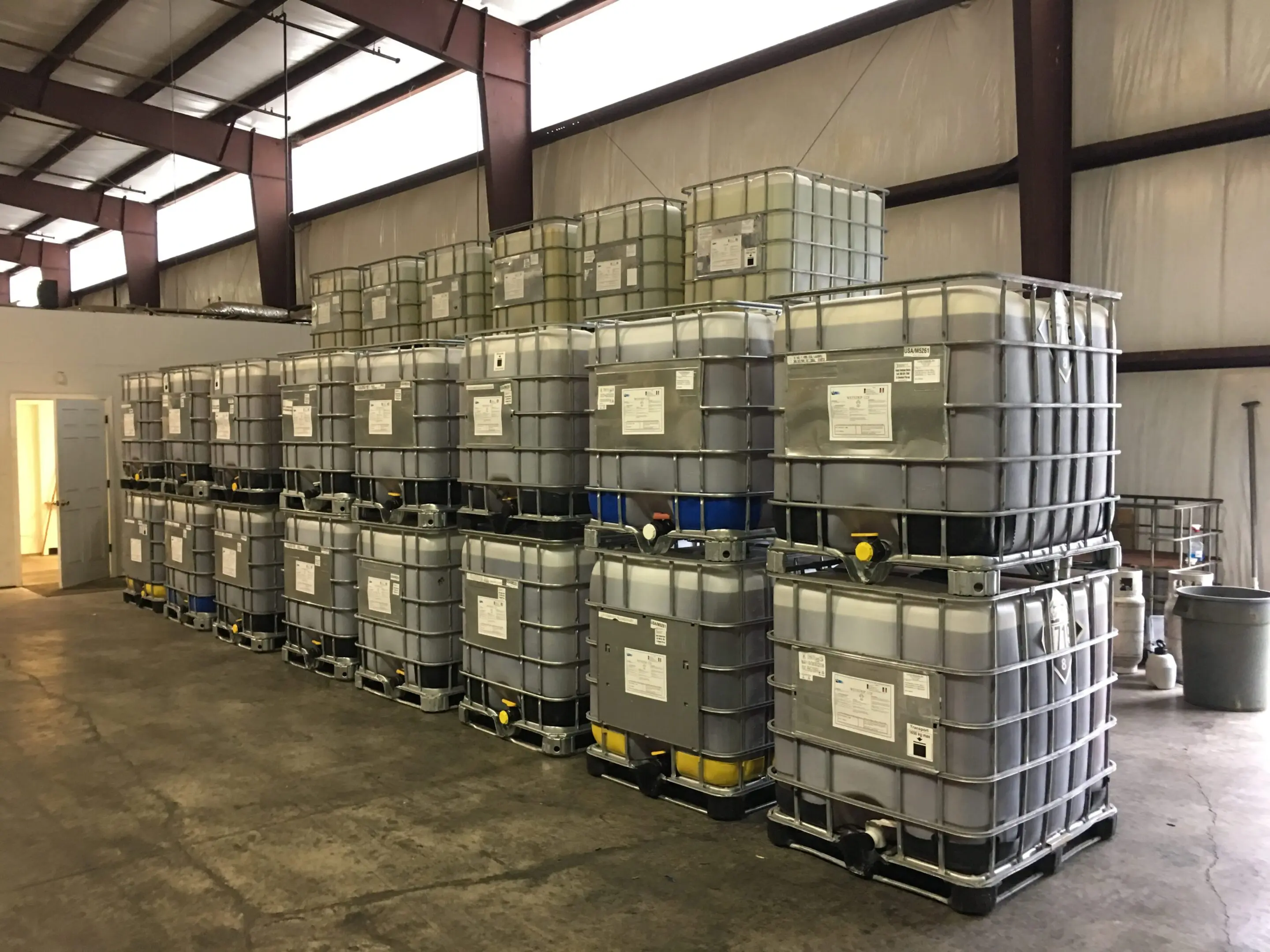 A warehouse filled with large metal barrels.