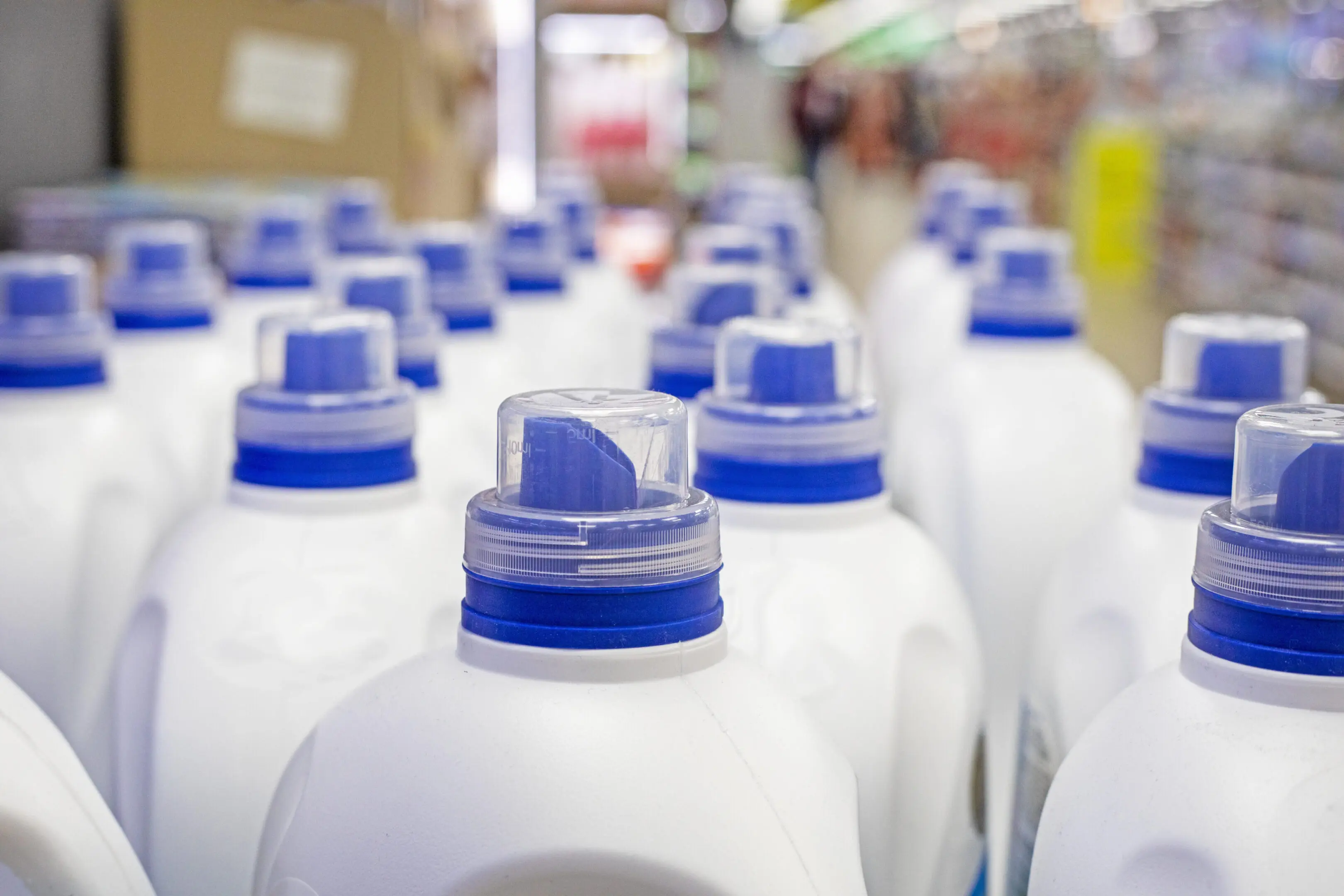 A row of milk jugs lined up in rows.